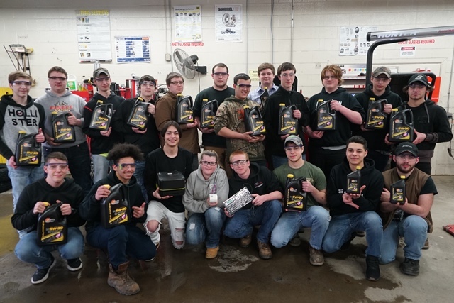 Auto Tech students holding Valvoline oil products