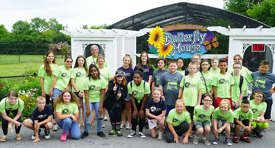 group picture of campers outside of butterfly house 