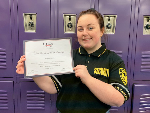 Hayley holding certificate of scholarship 
