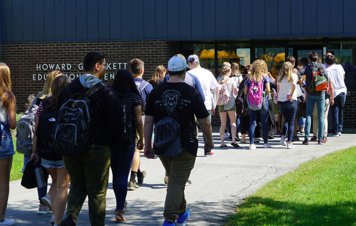 students walking into school building 