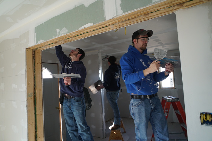 students installing drywall 