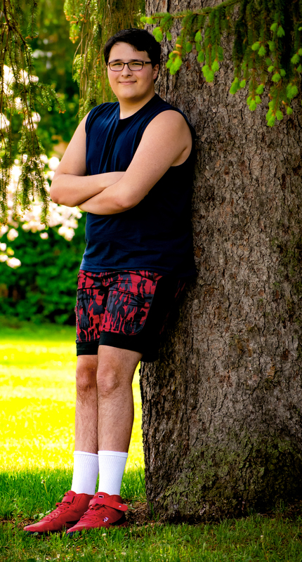 Christian Farrington standing next to tree