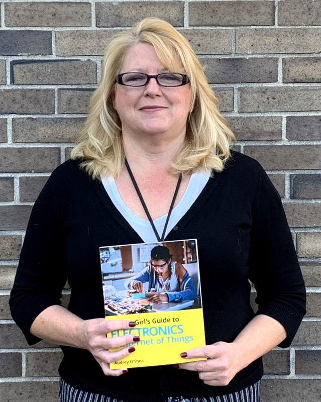 Ms. OShea holding book