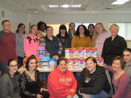 Adult Practical Nursing students with their donated baby formula 