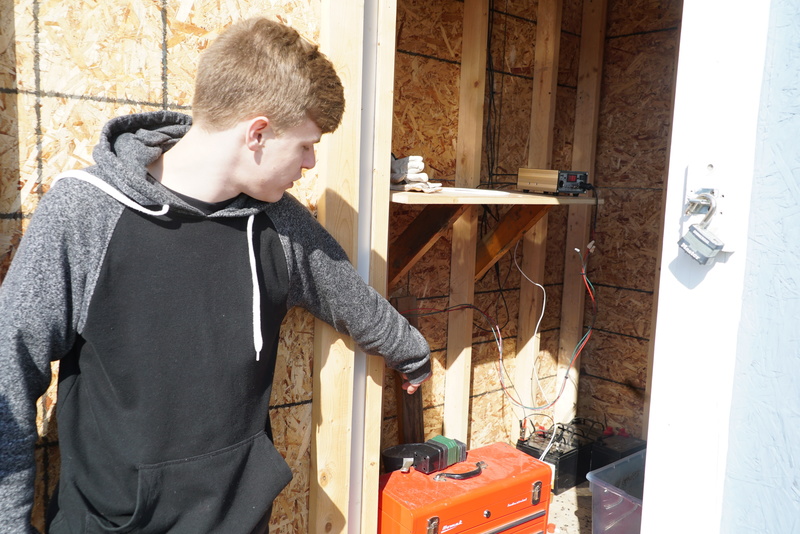 Bryan Nielsen shows off the wiring inside the shed