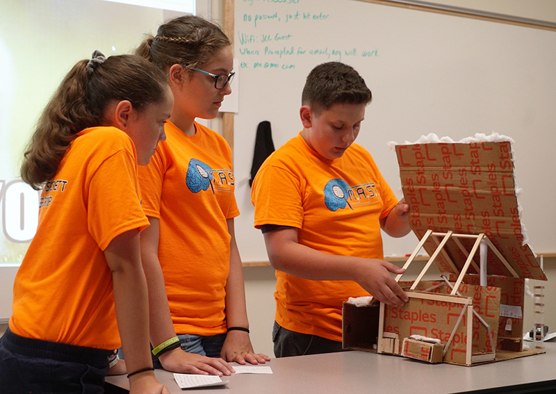 students show off their prototype model 